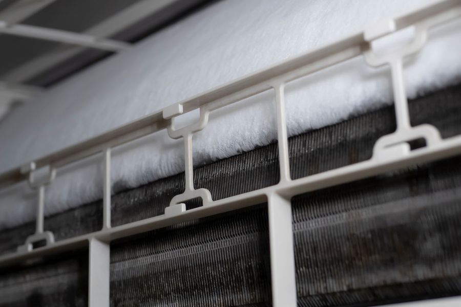 Close-up of a white plastic HVAC filter frame with fluffy filter material.