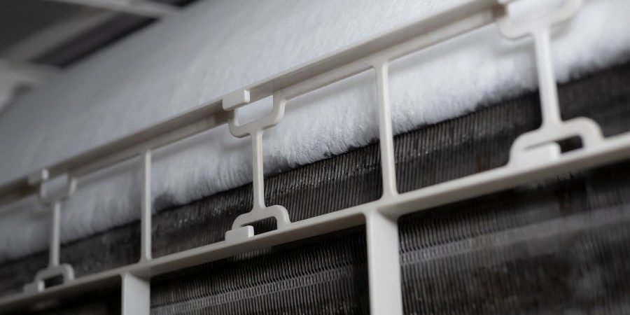 Close-up of a white plastic HVAC filter frame with fluffy filter material.